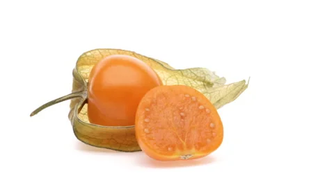 One whole and one-half cut physalis fruits rotating on white background. Stock Footage 166223946