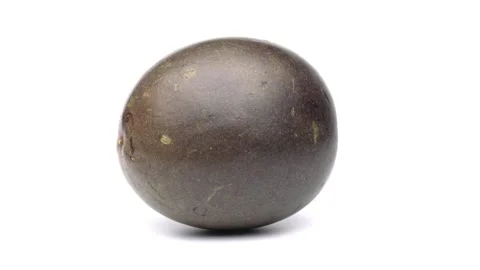 One whole passion fruit is rotating on white background. Stock Footage 158555312