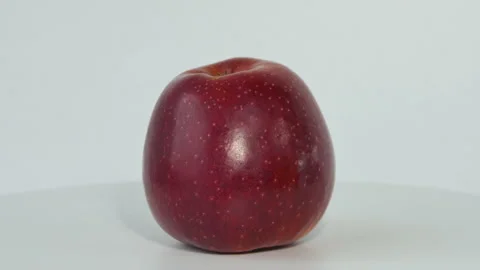 One whole red apple rotating. Macro shot of a red apple. An apple rotates around Stock Footage 194729719