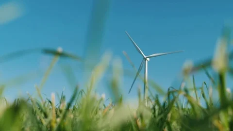 One wind generator, in the foreground a green grass. Clean energy and the Stock Footage 83301433