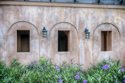 One window on the old brick wall covered with green leaves ivy plant Stock Photos