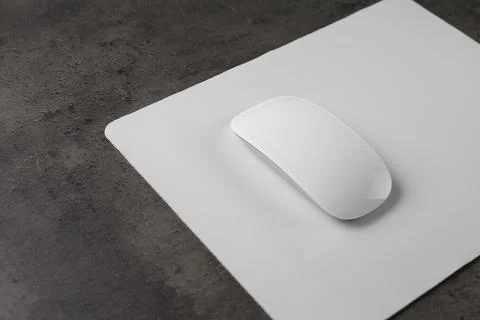 One wireless mouse with mousepad on black textured table, closeup. Space fo.. Foto stock