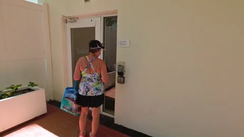 One woman uses code to open door leading to beach at Radisson hotel Video stock 295442053