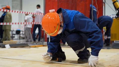 One worker man uses tape measure to take measurements, make marks Stock Footage 126357013