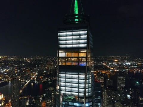 One World Trade Center glowing at night long range overhead aerial view in NYC Stock-Footage 76969052