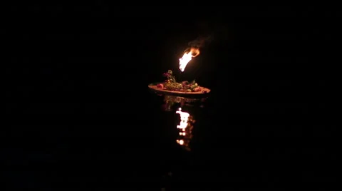 One wreath with torch floats down the river Stock Footage 47070793