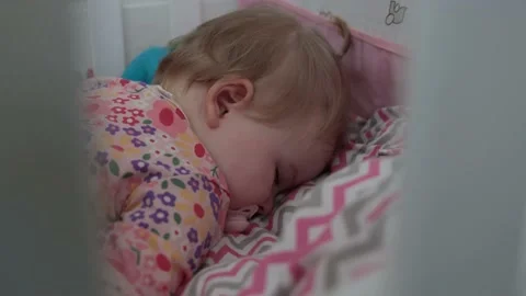One year old baby sleeping face down in her baby bed. Todler sleeping with pacif Stock Footage 234881538