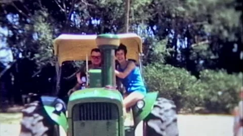 One year old boy and mom riding big tractor with adult farmer Stock Footage 194521840