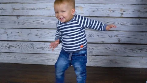 One year old boy dances in the room. Slow motion Video stock 82732326