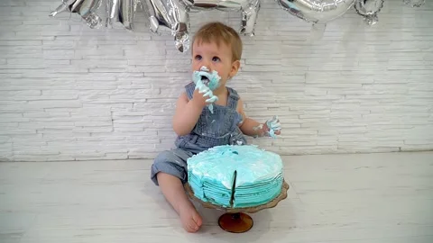 One-year-old boy eating cake on his first birthday, happy infant baby Stock Footage 262651219
