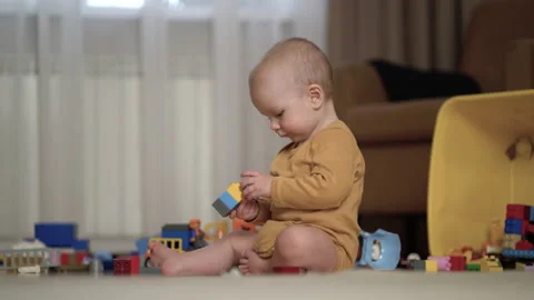 One year old boy play colorful blocks set sit on floor and enjoy game at home. Stock Footage 219494632
