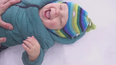 One year old boy plays in the snow yard with father 스톡 동영상 91172177