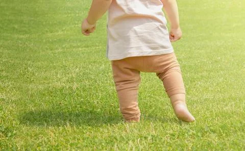 A one-year-old child is learning to walk Stock Photos