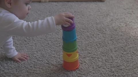One year-old child playing with educational cup toys at home. Little baby boy Video stock 163309540