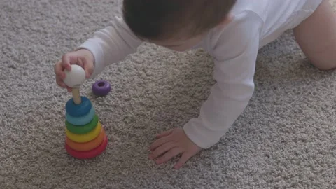 One year-old child playing with educational cup toys at home. Little baby boy Video stock 163310247