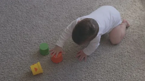 One year-old child playing with educational cup toys at home. Little baby boy Video stock 164898675
