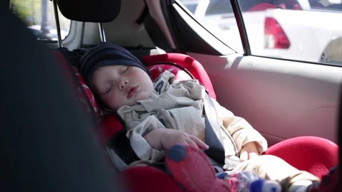 One-year-old child sleeping in a car seat. Stock Footage 90101919