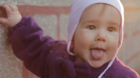 One year old girl showing her tongue (2/3) Stock Footage 48383953