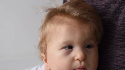 One year old happy disabled child is jumping on his mother’s knees - video Stock Footage 102344005