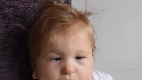 One year old happy disabled child is jumping on his mother’s knees -  video Stock Footage 102344141