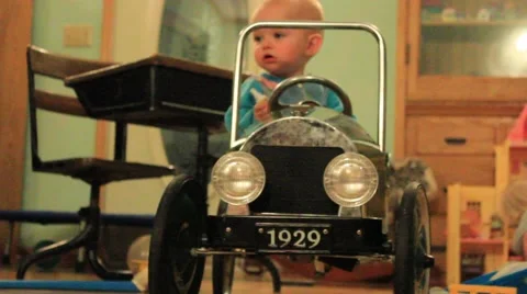 One year old steers wheel in vintage car Stock Footage 41743066