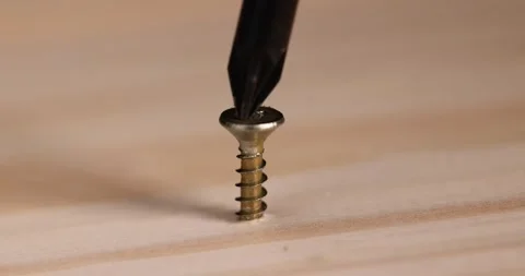 One yellow metal self tapping screws for fastening are used in construction, Stock Footage 299563845