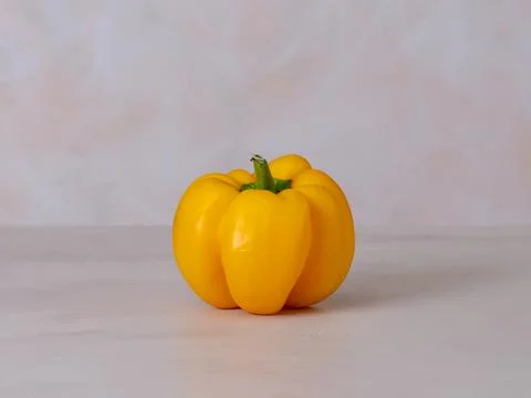 One yellow pepper, light background, photo straight on, vegan diet ingredie.. Stock Photos