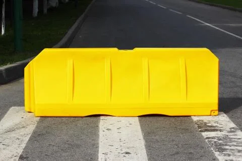 One yellow plastic barrier is blocking the road. Stock Photos