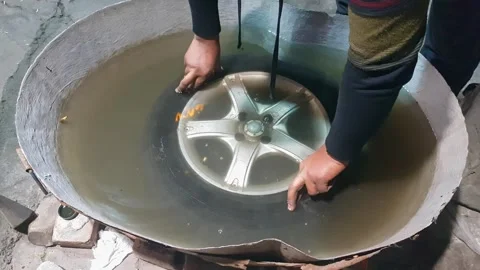 One young adult worker checking the tire puncture of a car in water tub. Stock Footage 341164394
