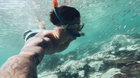 One young beautiful active man swimming and enjoying vacations outdoor in the se Stock Footage 249692463