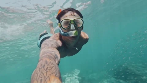 One young beautiful active man swimming and enjoying vacations outdoor in the se Stock Footage 249692663