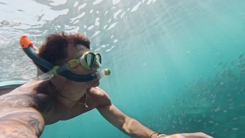 One young beautiful active man swimming and enjoying vacations outdoor in the se Stock Footage 249694272