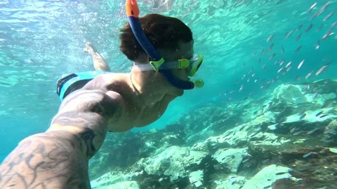 One young beautiful active man swimming and enjoying vacations outdoor in the se Stock Footage 249694730