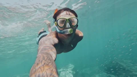 One young beautiful active man swimming and enjoying vacations outdoor in the se Stock Footage 249695473