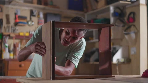 One young black carpenter apprentice working at carpentry workshop building.. Video stock 246846808