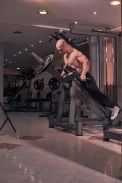 One young bodybuilder, exercise equipment, chest arm, gym indoors. full lengh Stock Photos