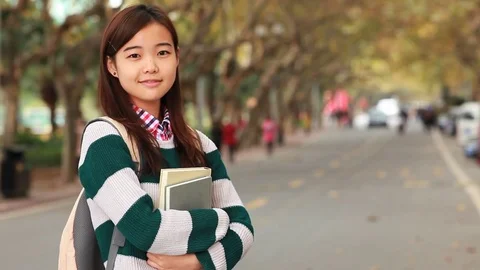 One young Chinese College girl student smile at camera Stock Footage
