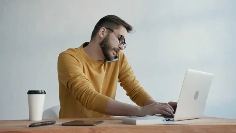 One young creative person working with glasses and portable pc at table. Online Stock Footage 199474754