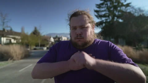 One young fat man having chest pain. Overweight person with panic attack fe.. Stock Footage 231149431