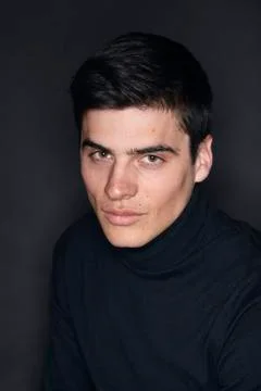 One young handsome man, model wearing turtleneck, simple studio upper body sh Stock Photos