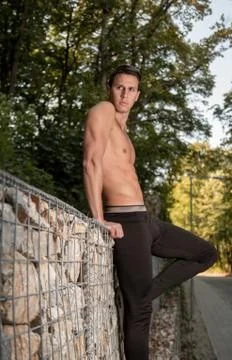 One young handsome man posing, shirtless forest fitness body muscular rocks,  Stock Photos