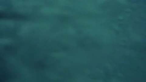 One young happy man running and jumping off from a cliff to the water holding Stock Footage 221877437