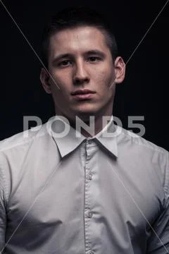 One young man, face head headshot close-up, black background Stock Photos