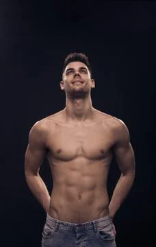One young man looking above up, shirtless body fit abs Stock Photos