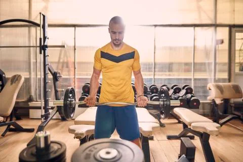 One young man, looking down, sport clothes, in old beaten up gym indoors, exe Stock Photos