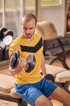 One young man, looking down sideways, profile view, sport clothes, in old bea Stock Photos