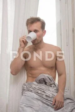 One young man only, drinking cup, shirtless body curtain Stock Photos