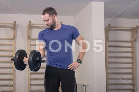 One young man only, muscular exercise one dumbbell Stock Photos