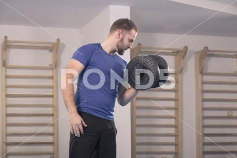 One young man only, muscular exercise, one dumbbell Stock Photos