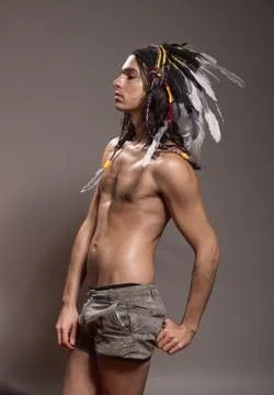 One young man posing shirtless war bonnet hairstyle Stock Photos